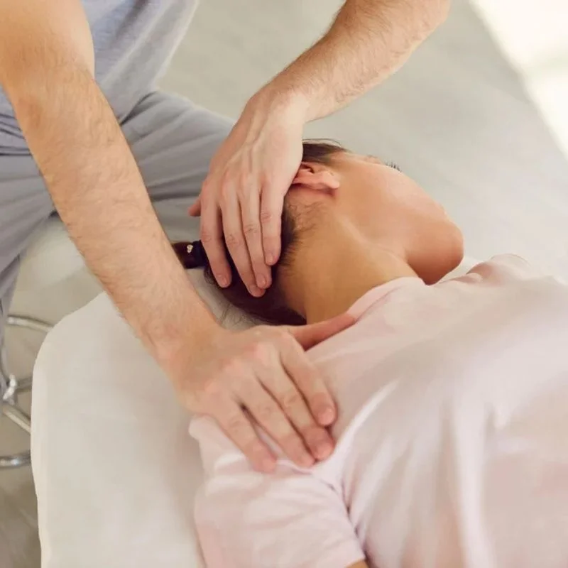 chiropractor performing cervical neck adjustment during rehabilitation treatment in Whitby