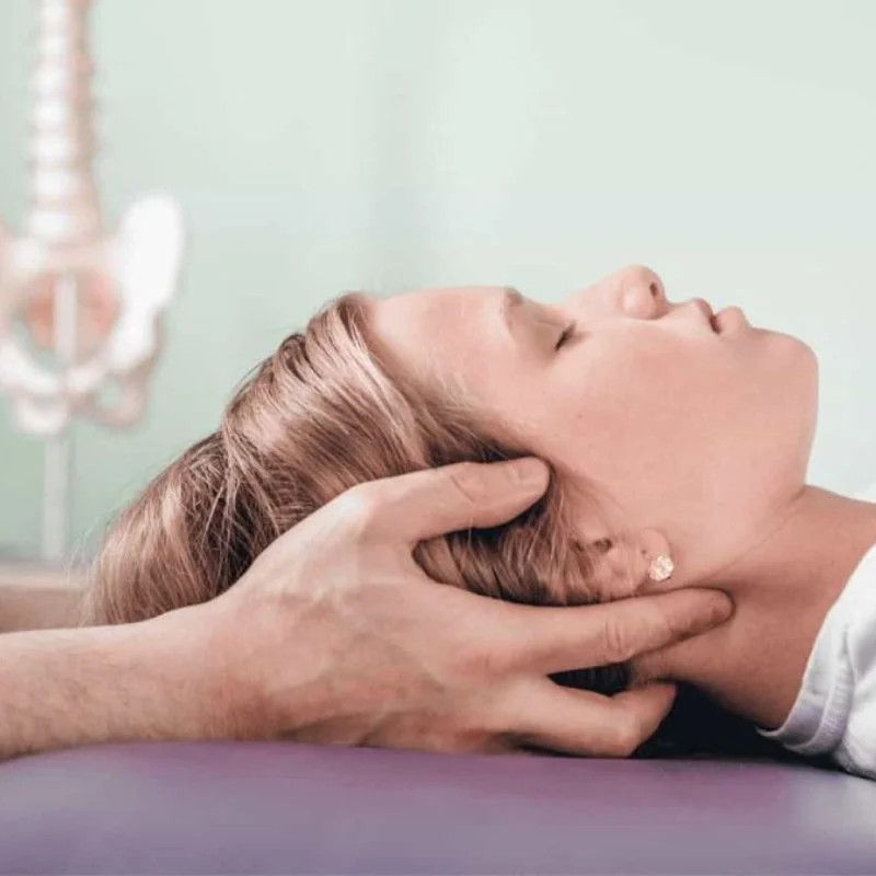 chiropractor performing cervical manipulation for headache relief in Whitby