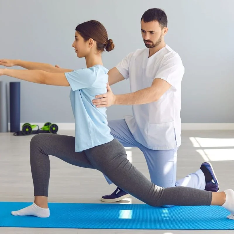 rehabilitation therapist guiding patient lunge exercise for balance and strength in Whitby