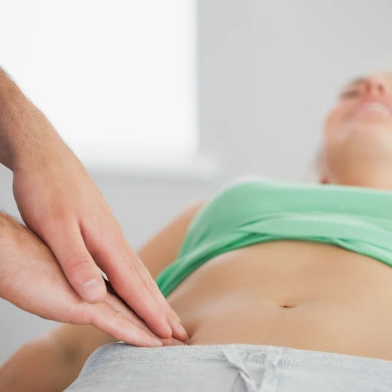 physiotherapist performing external abdominal assessment for pelvic floor treatment in Whitby